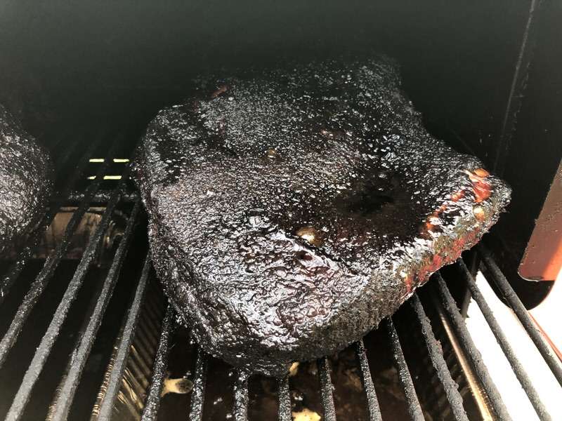 Beautiful black bark briskets smoking on the MAK 2 Star pellet grill. These two briskets were smoked on the upper full rack with drip pans underneath.