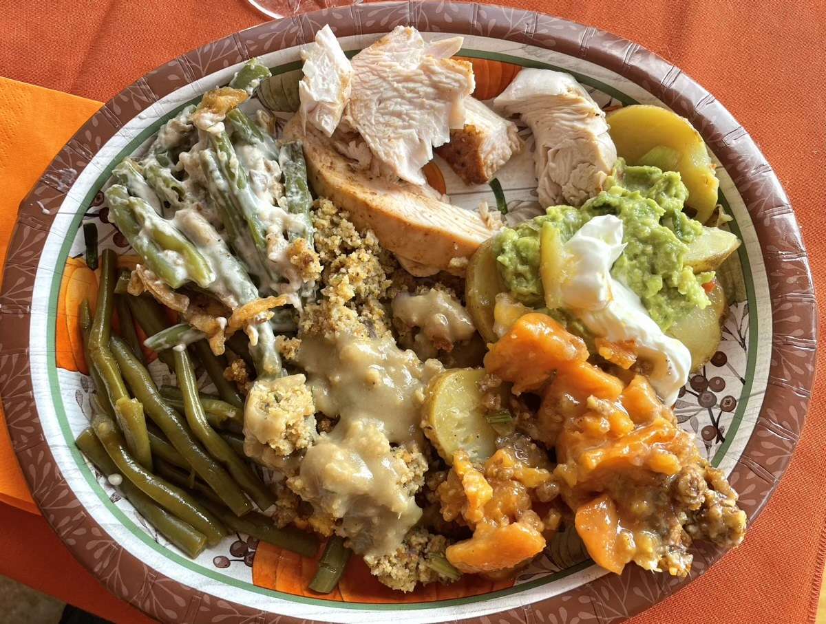 Final Thanksgiving plate with turkey, dressing, green beans, Irish nachos, and sweet potato casserole. Yum!
