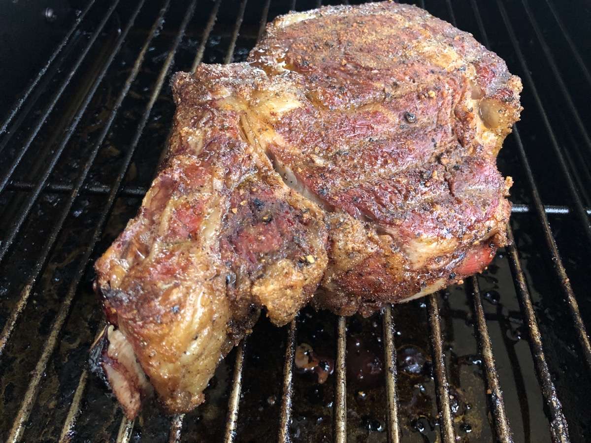 3lb Bone-in Ribeye slowly cooking in MAK 2 Star pellet grill side smoker. The steak started to get some beautiful color before we ever grilled it on the MAK searing grates.