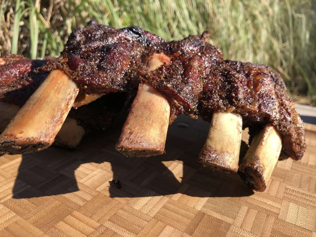 Beef finger ribs cooked on Pit Barrel Cooker resting on cutting board right before we sliced them.