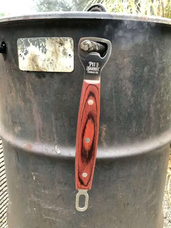 Ultimate Hook Tool features a bottle opener and hangs nicely on the rebar on the Pit Barrel Cooker.