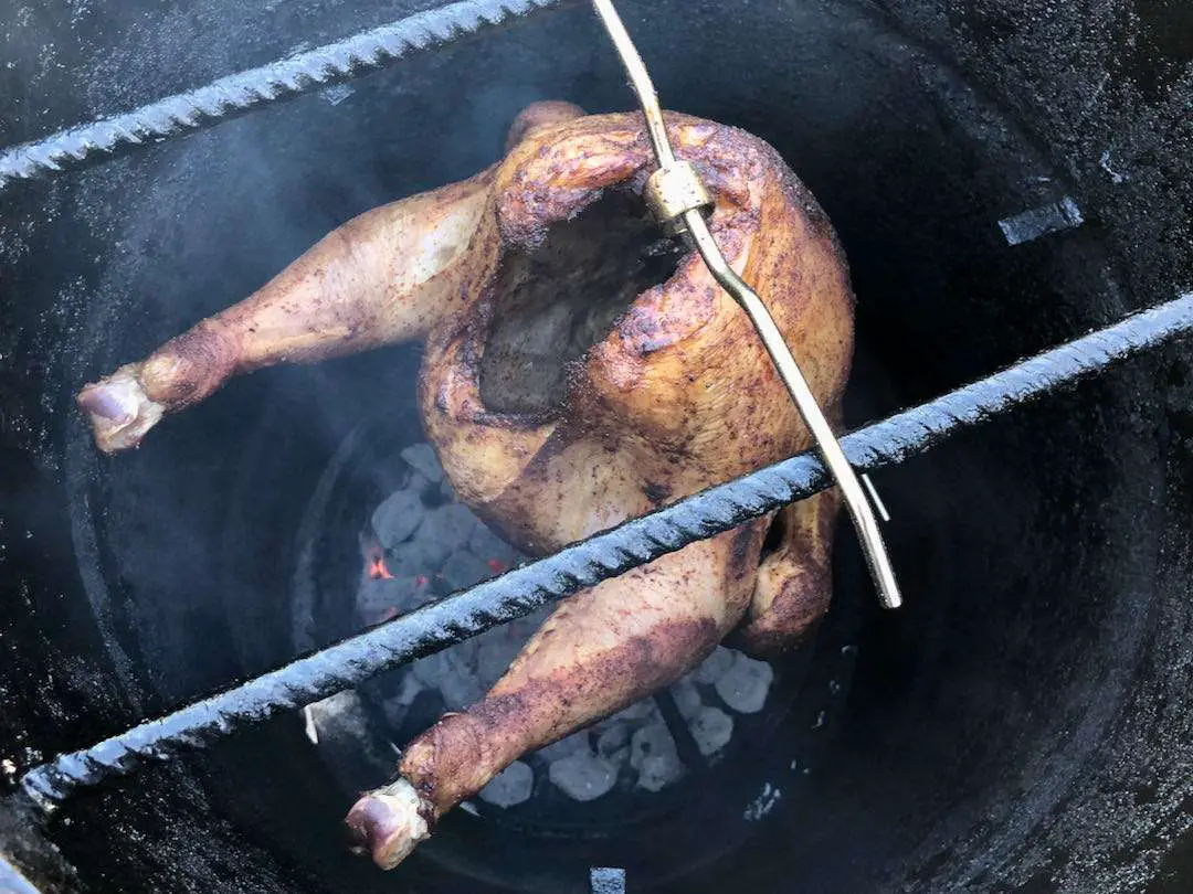Full size turkey smoking on the Pit Barrel Cooker using their turkey hanger accessory.