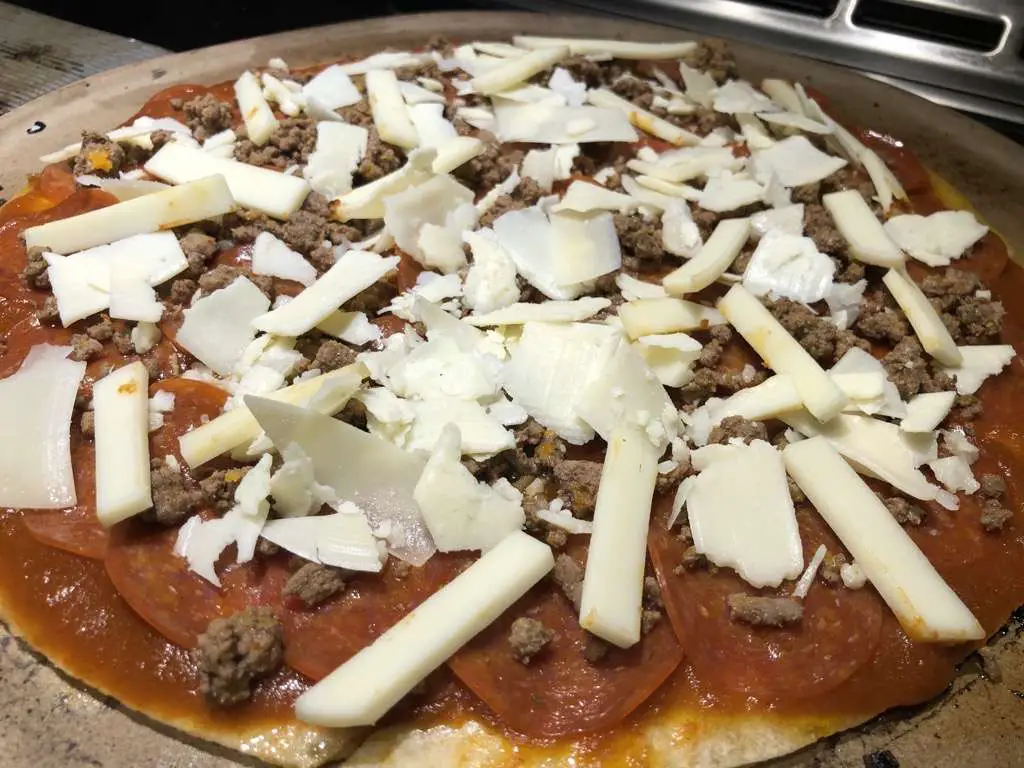 Second pizza was prepared with sauce, pepperoni, shaved parmesan, provolone, ground beef, and SuckleBuster's 1836 Beef Seasoning