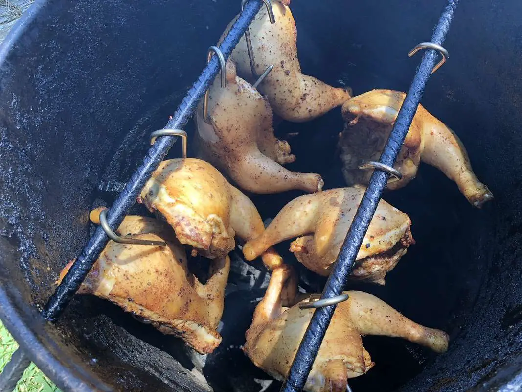 Quarter chickens hanging on the Pit Barrel Cooker