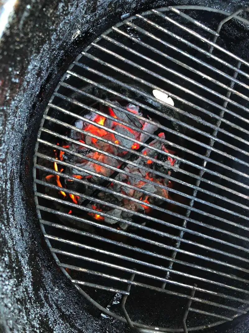 Blazing hot charcoal fire in Pit Barrel Cooker for cooking steaks