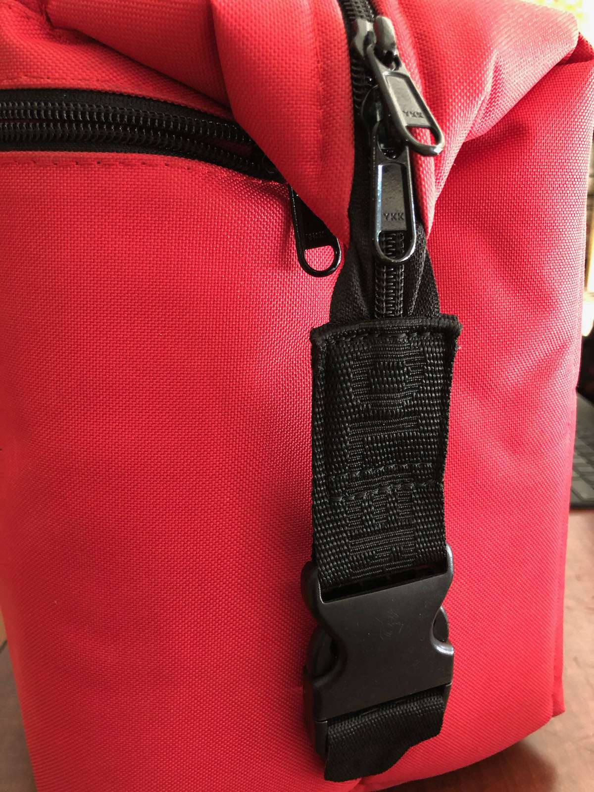 Side buckles fasten down on AO 12 Pack Cooler for a more compact, efficient design.