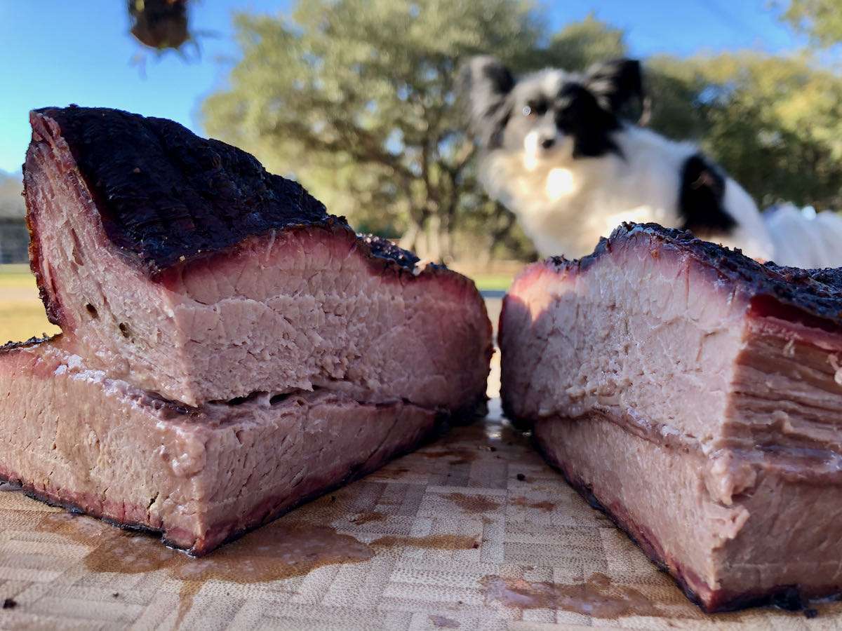 A beautiful bark and smoke ring rendered out on this brisket. As you can see, I have my barbecue buddy in the background watching me closely!