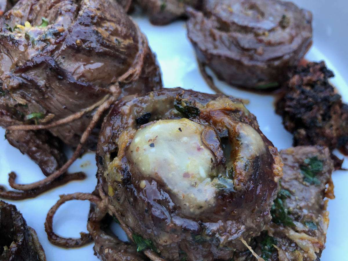 Final skirt steak pinwheels with a good sear on the outside and a melted cheese center.