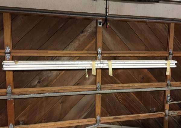 8′ fluorescent light mounted to wood garage door