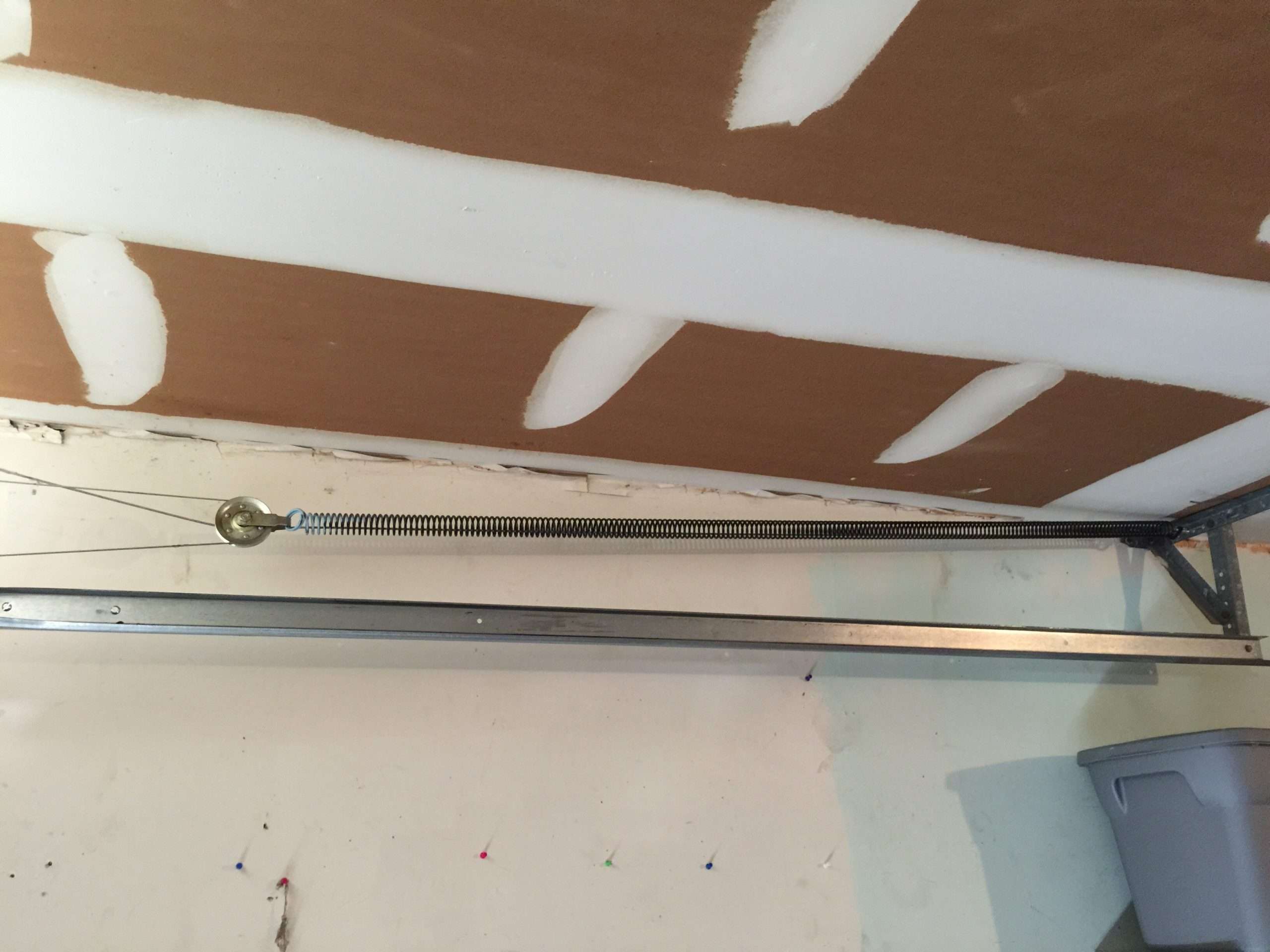 Stretched garge door extension spring above the horizontal track.