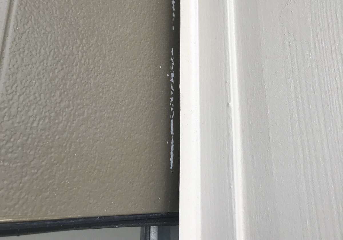 Painting the part of the garage door that sits behind the vinyl trim can cause it to stick to the trim therefore causing damage to your garage door when opened.