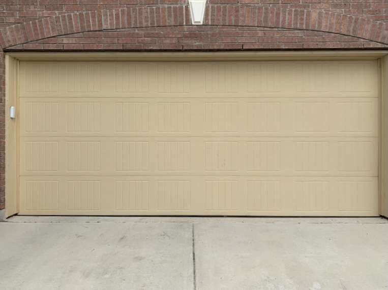 Painting your garage door in the down position will prevent getting paint in between the sections and behind the vinyl trim