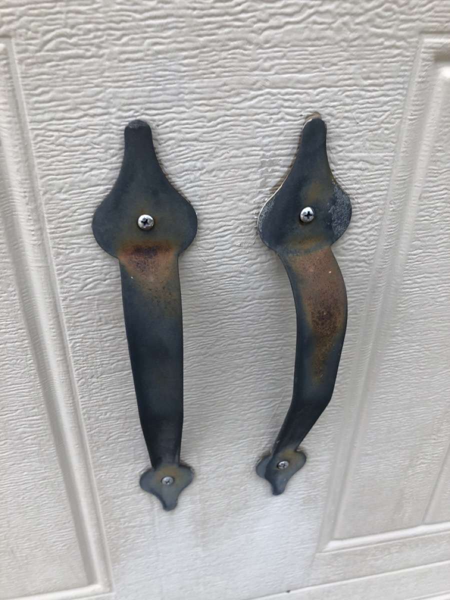 Rusted and faded decorative metal garage door handles