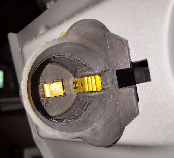 Brass contacts in garage door opener light bulb socket