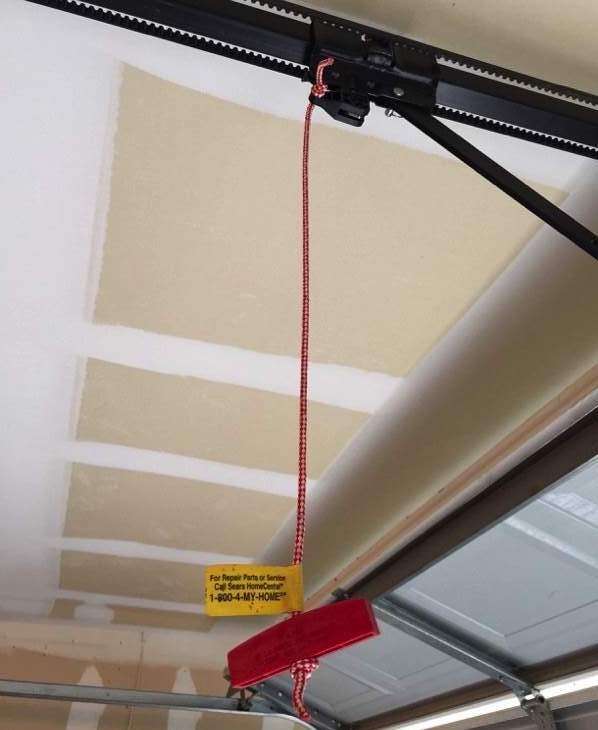 Red emergency release rope on Chamberlain garage door opener