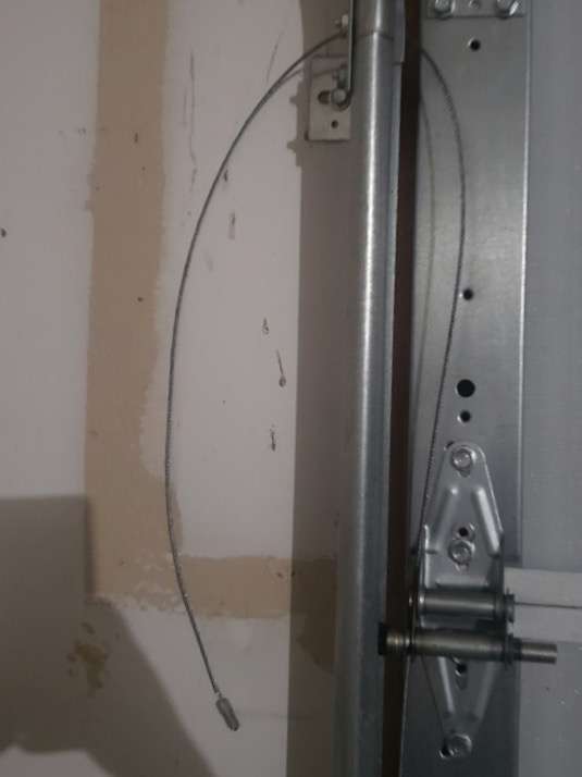 Loose torsion cable on garage door