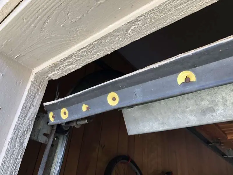 Bottom nail on weather seal on wood garage door