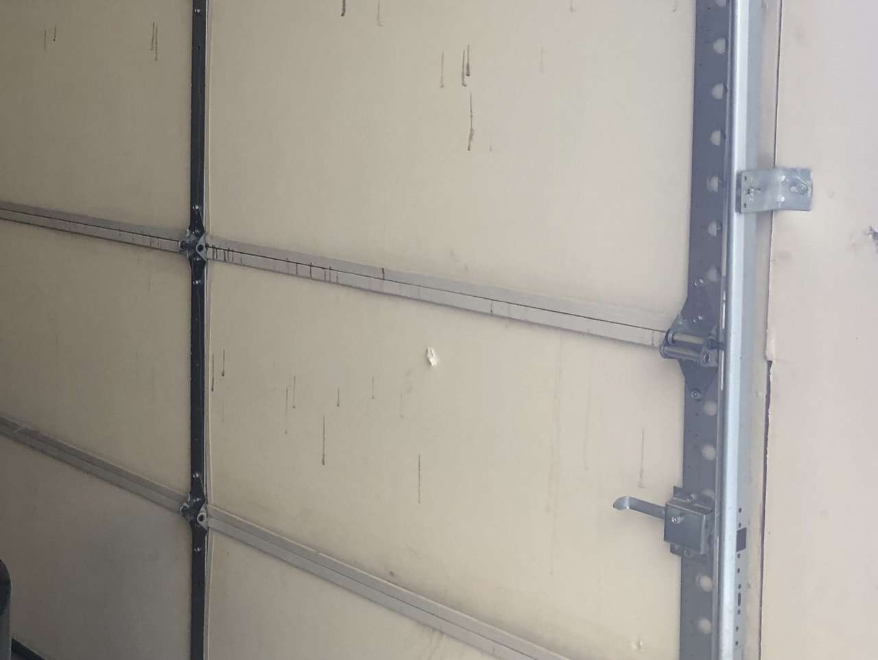 Vinyl back insulated garage door with punctures and knicks in the insulation. We have seen doors far worse than this.