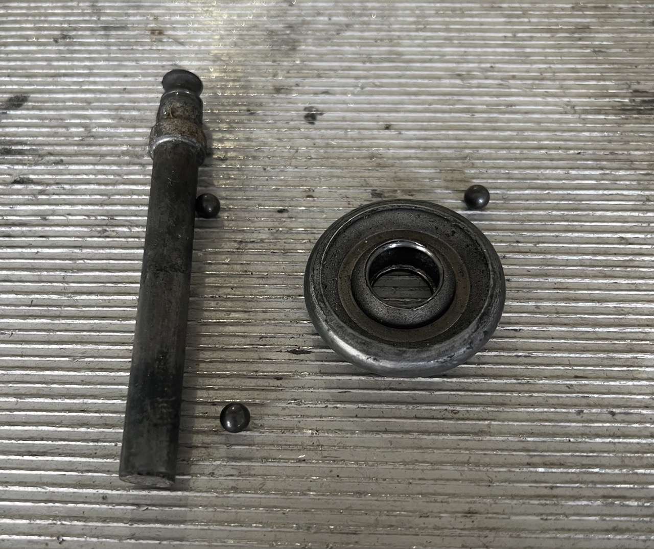 Stem completely broke off metal garage door roller. You can see the ball bearings in the picure.