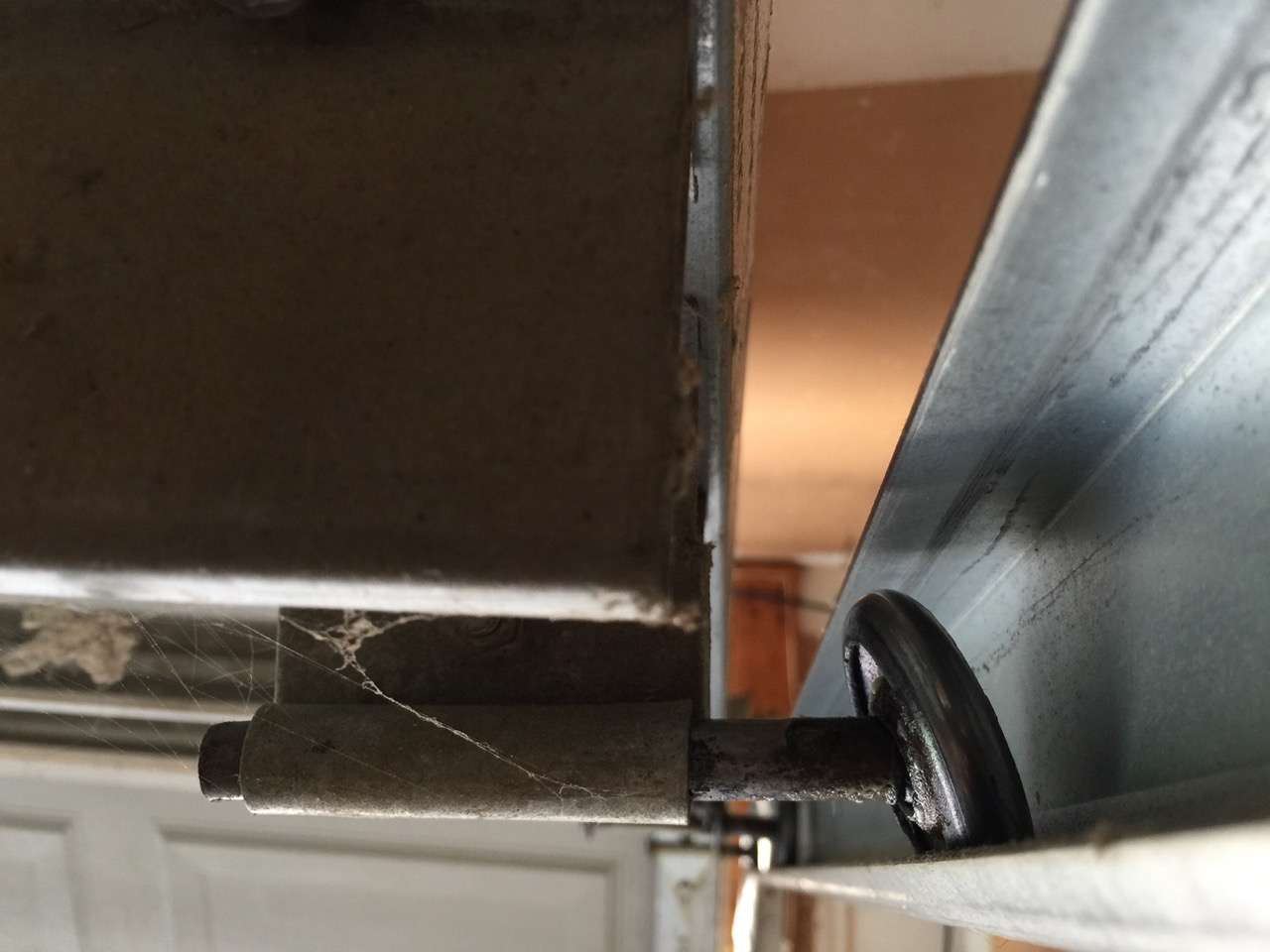 Worn garage door roller with failed bearings that needs replacement
