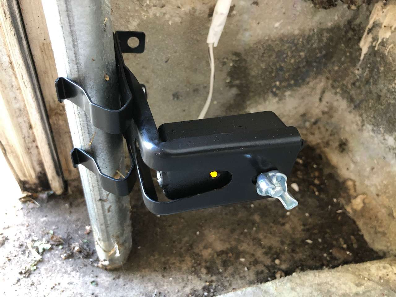 LiftMaster sensors mounted to garage door vertical tracks. If the tracks are too tight, the sensors can move as the door lowers causing it to reverse.