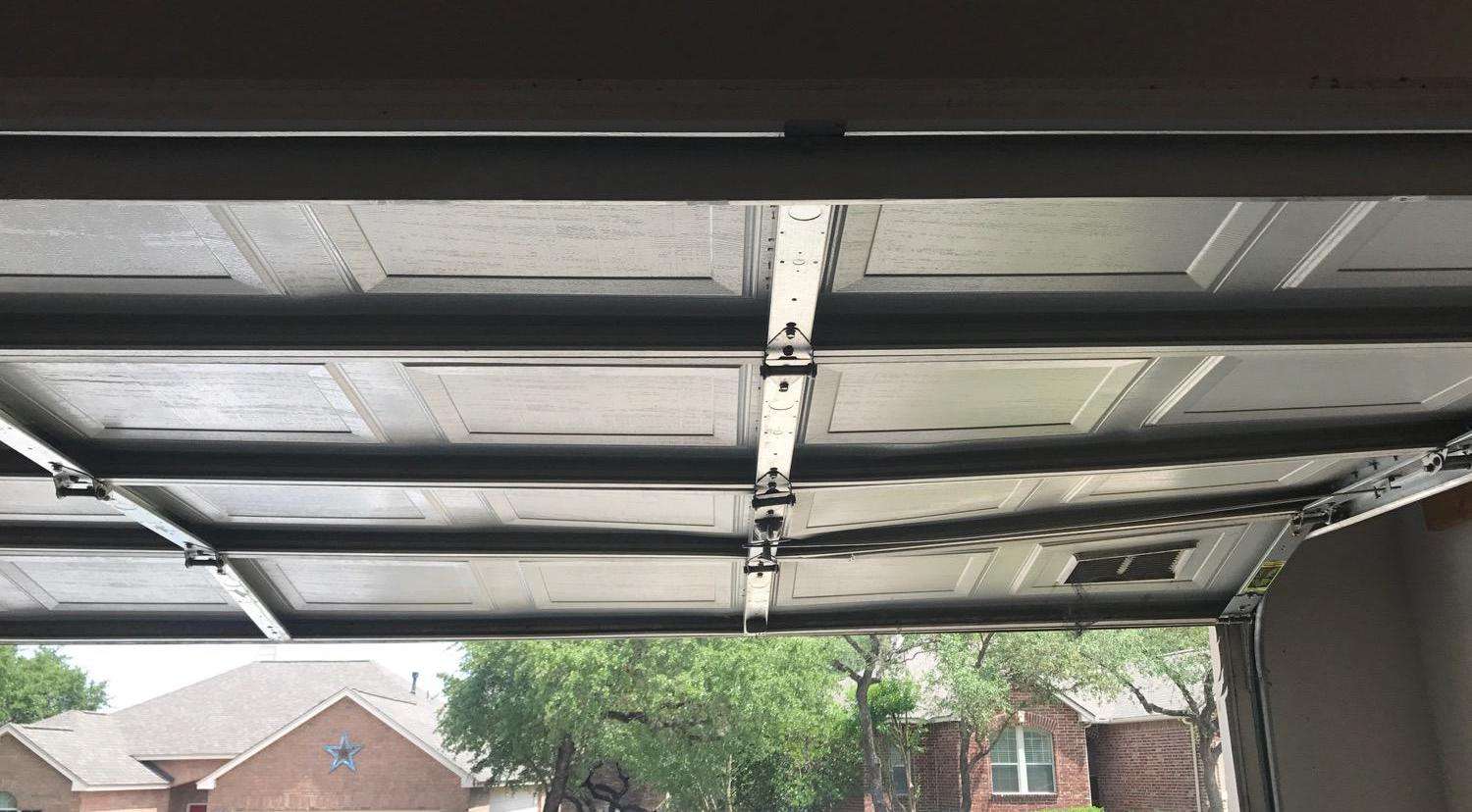 The bottom and second sections are sagging on this garage door.
