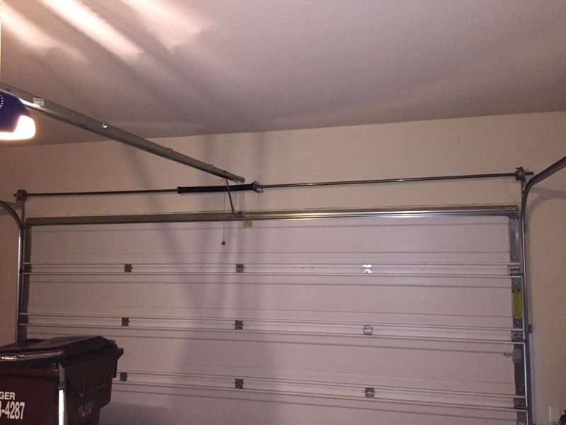 This is what your Wayne Dalton garage door will look like after the Torquemaster spring conversion to a standard torsion spring. You can see the torsion spring and shaft above the garage door.