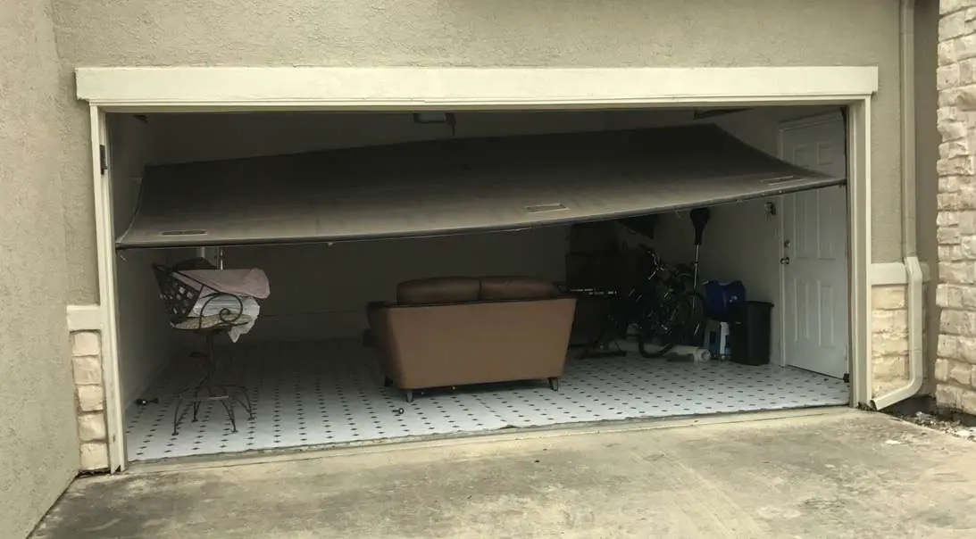 We call this the flying squirrel. This garage door only has two rollers in the tracks and is being held up by the garage door opener.