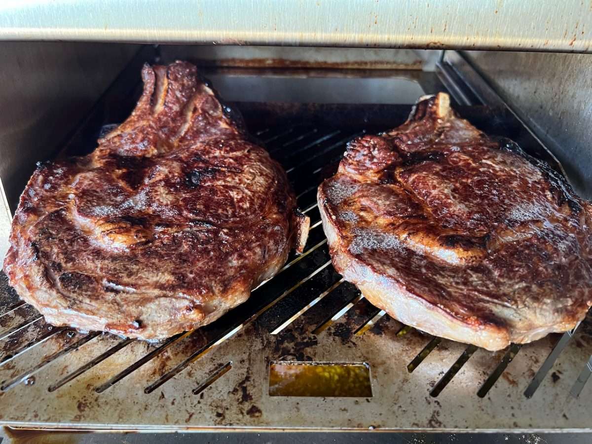 Beautiful crust starting to form on bone-in ribeyes on Schwank Infrared Grill.