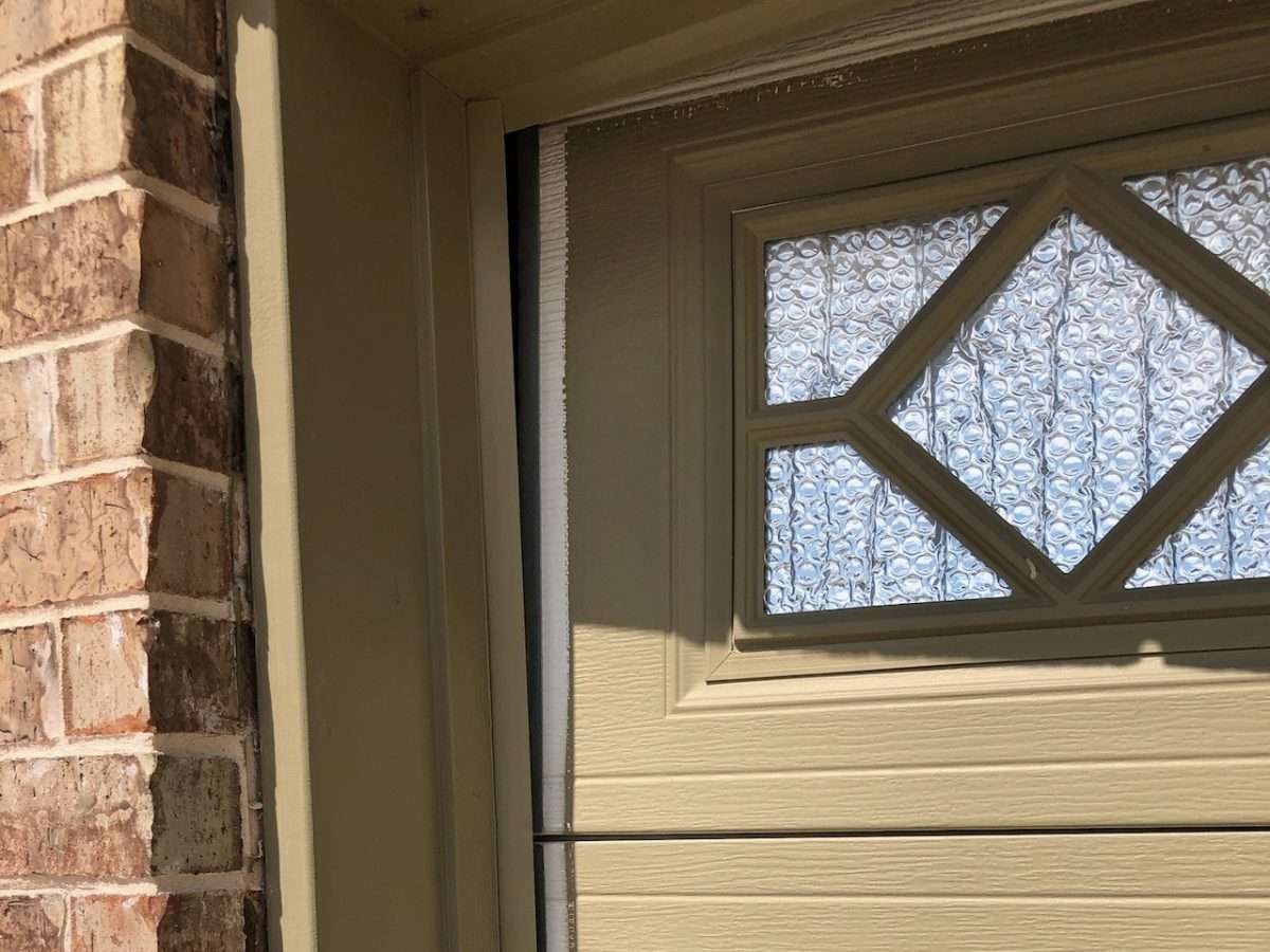 Custom painted garage door to match the home. YOu can see the original white color that sits behind the vinyl trim when the garage door is closed.