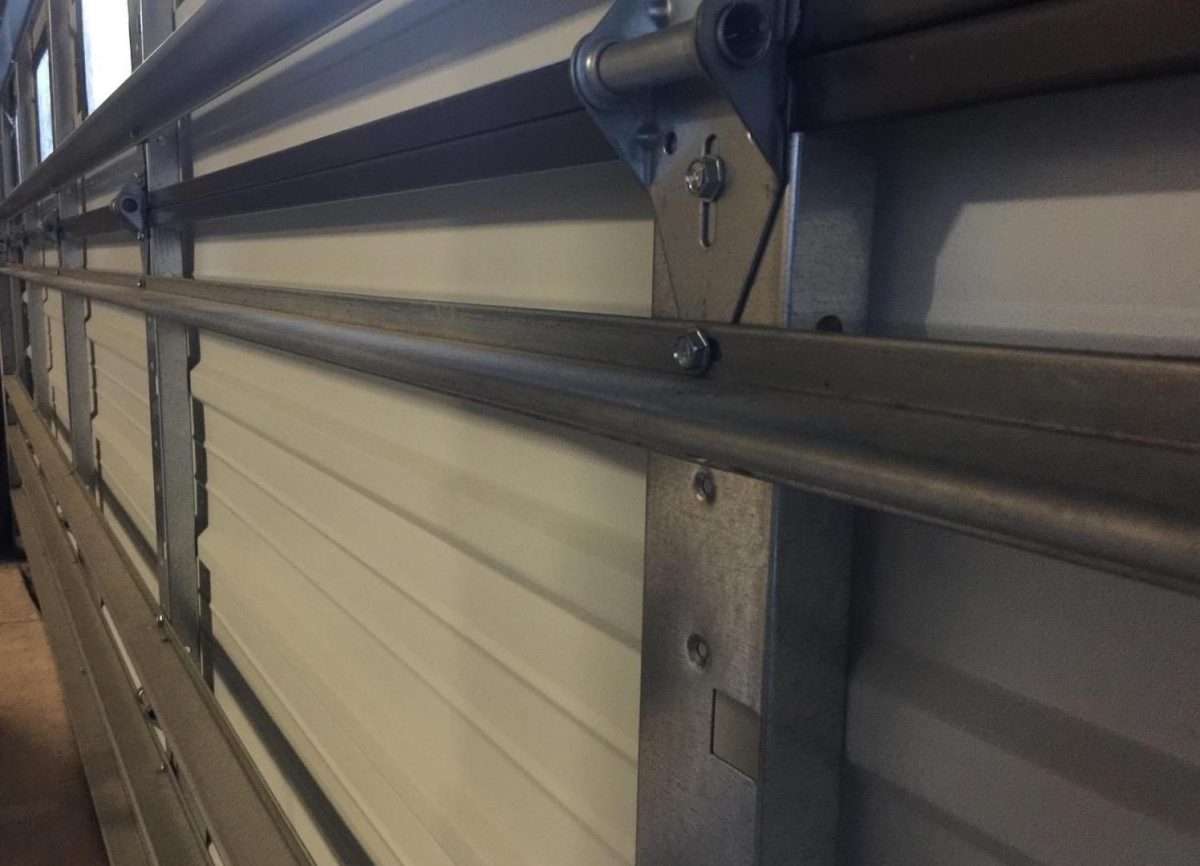 Reinforcement strut installed on garage door section