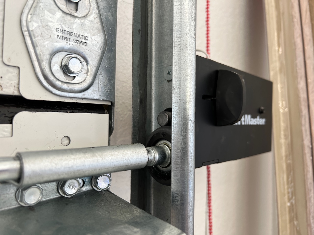 LiftMaster 841LM automatic lock installed on vertical track. If the door is raised, the roller will hit the deadbolt. 