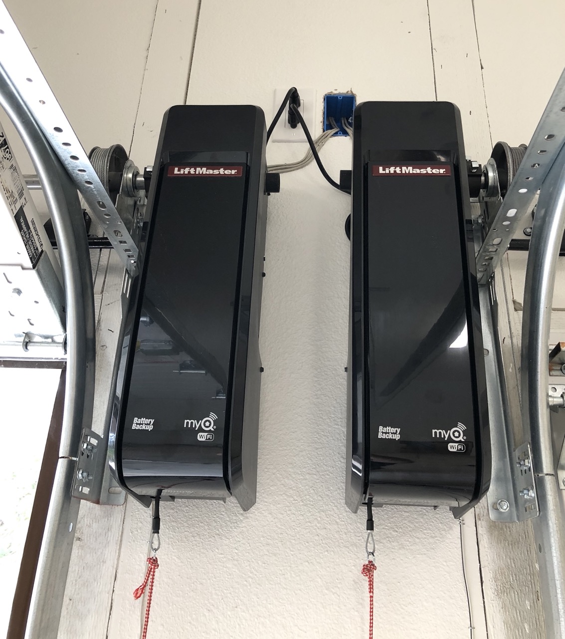 Two LiftMaster 8500W wall mount garage door openers we installed in the same garage. One is mounted on the right side of the garage door and the other is mounted on the left side.