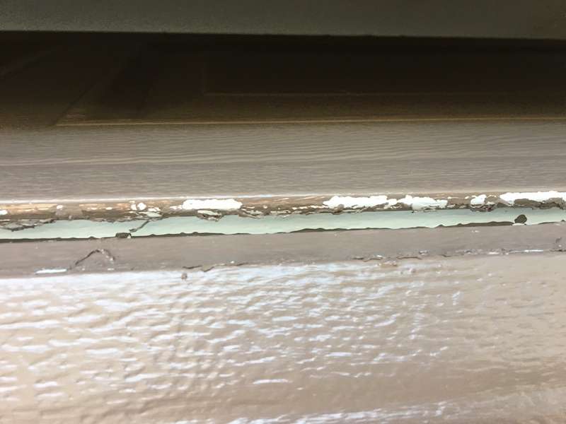 Paint in between the garage door sections causing issues when opening in the mornings.