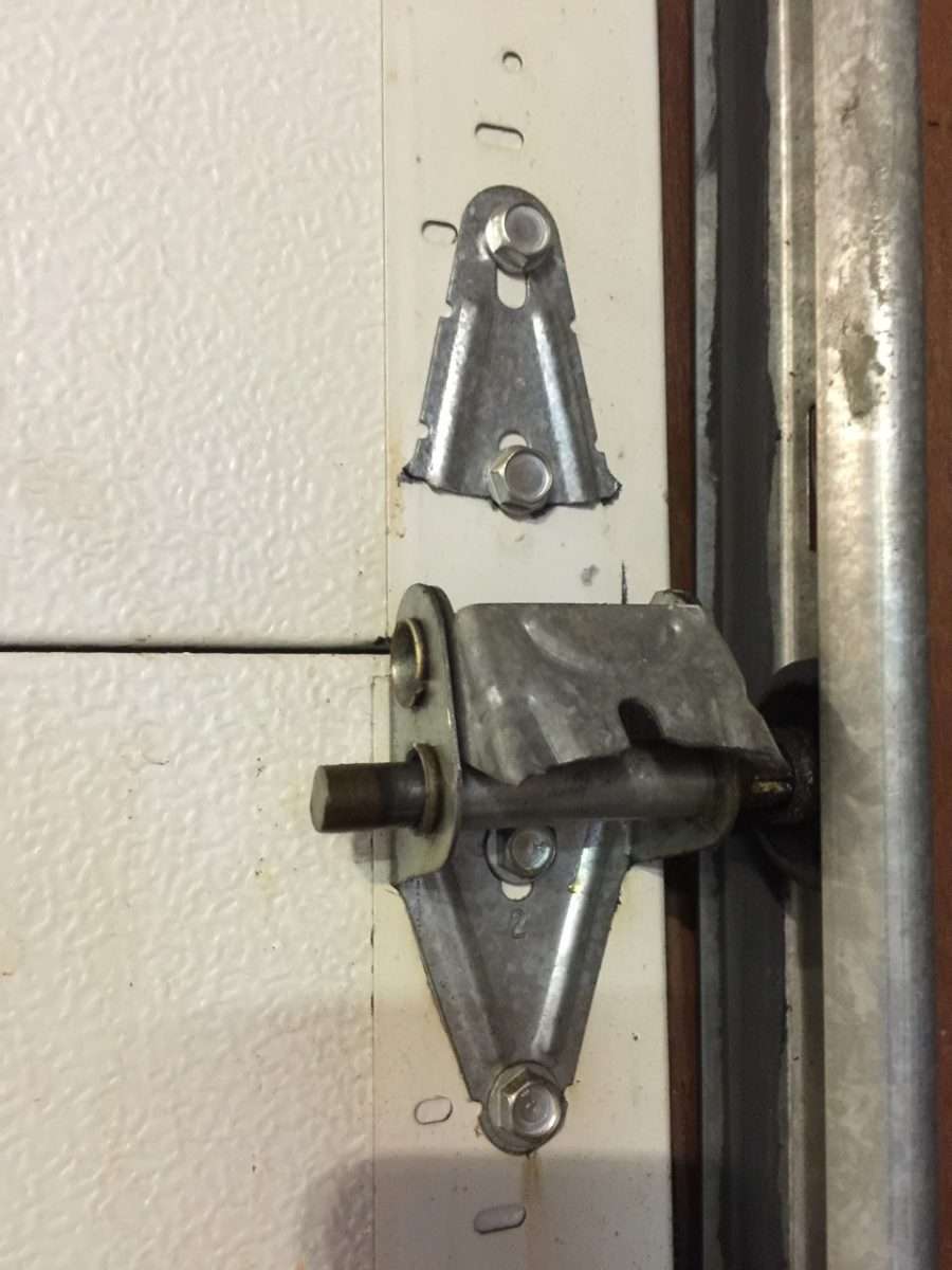 Broken hinge on steel back garage door.