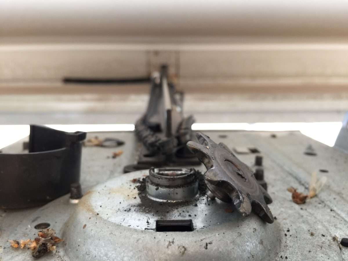 Broken chain drive sprocket that sheared off on a LiftMaster garage door opener.