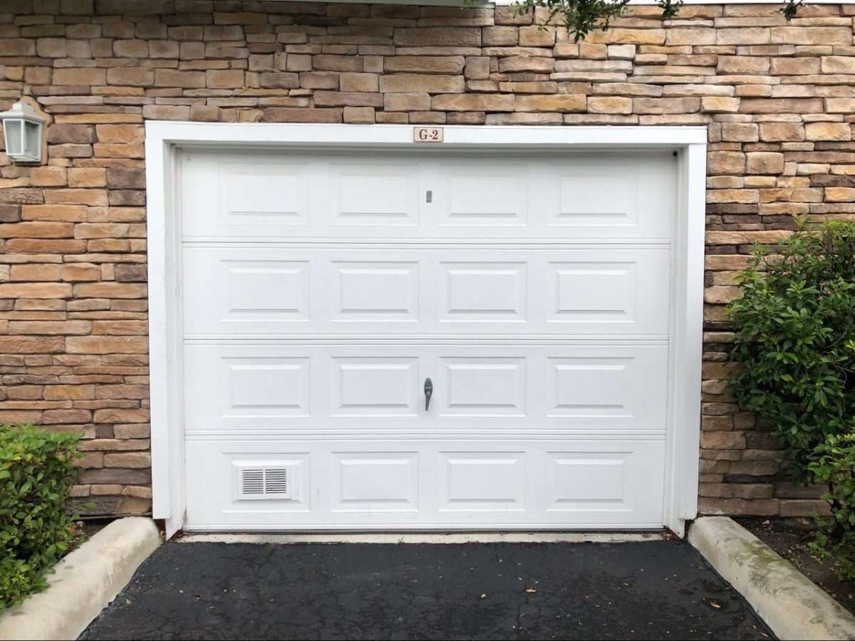Standard garage door with an emergency release lock and outside keyed lock installed.