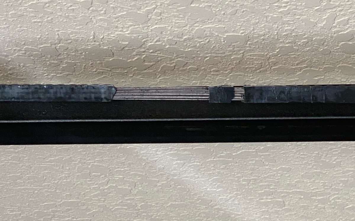 Stripped belt on a belt drive garage door opener. You can see the steel reinforcement inside the belt.