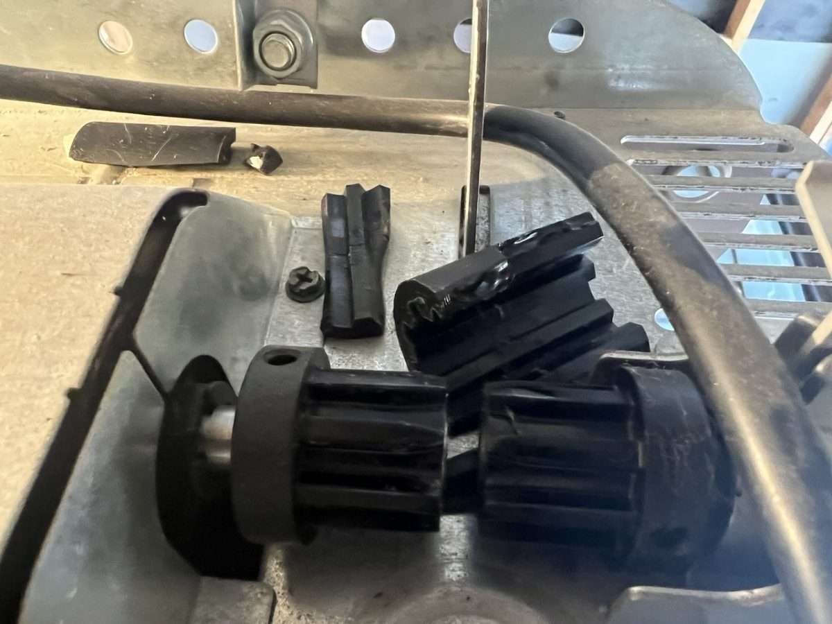 Broken coupler on top of LiftMaster, Chamberlain, or Craftsman garage door opener motor.