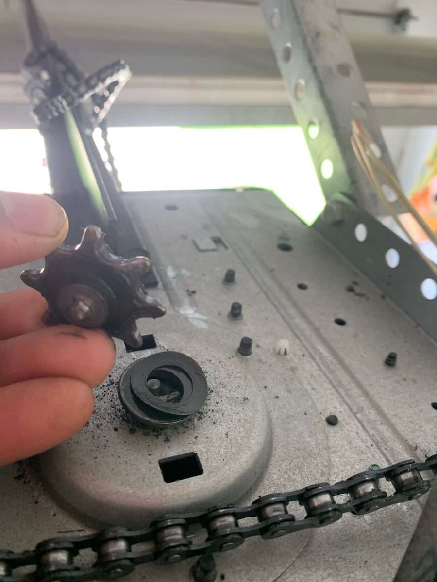 Broken chain drive sprocket on LiftMaster garage door opener.