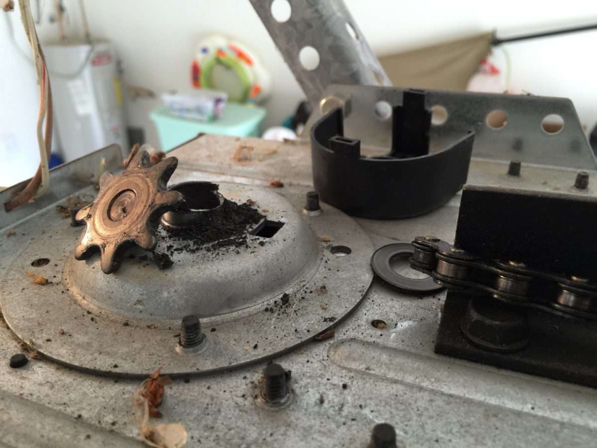 Broken sprocket on top of LiftMaster garage door opener motor.
