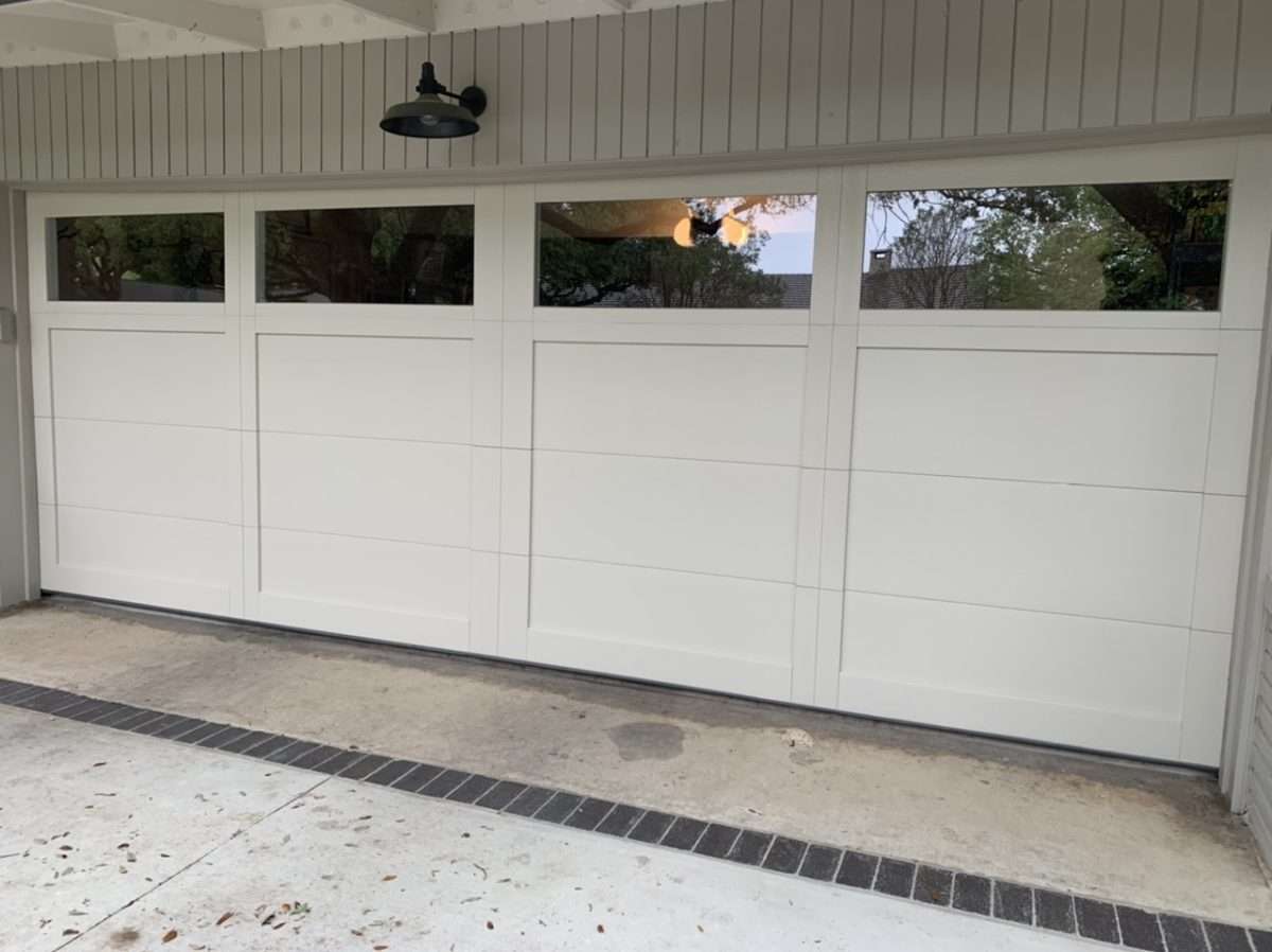 18ft wide 3” thick overlay garage door weighing over 400 LBS.