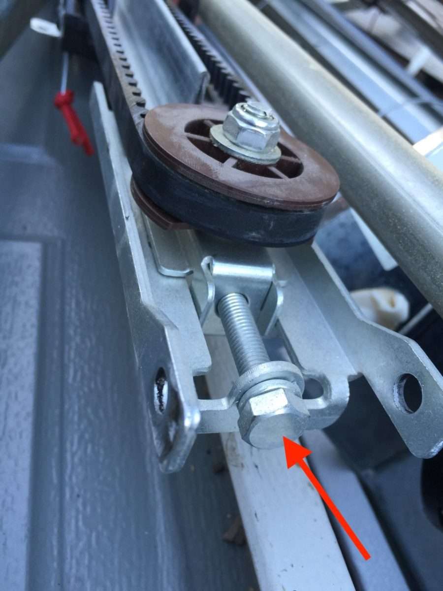 Front tensioner on Genie garage door opener header bracket.