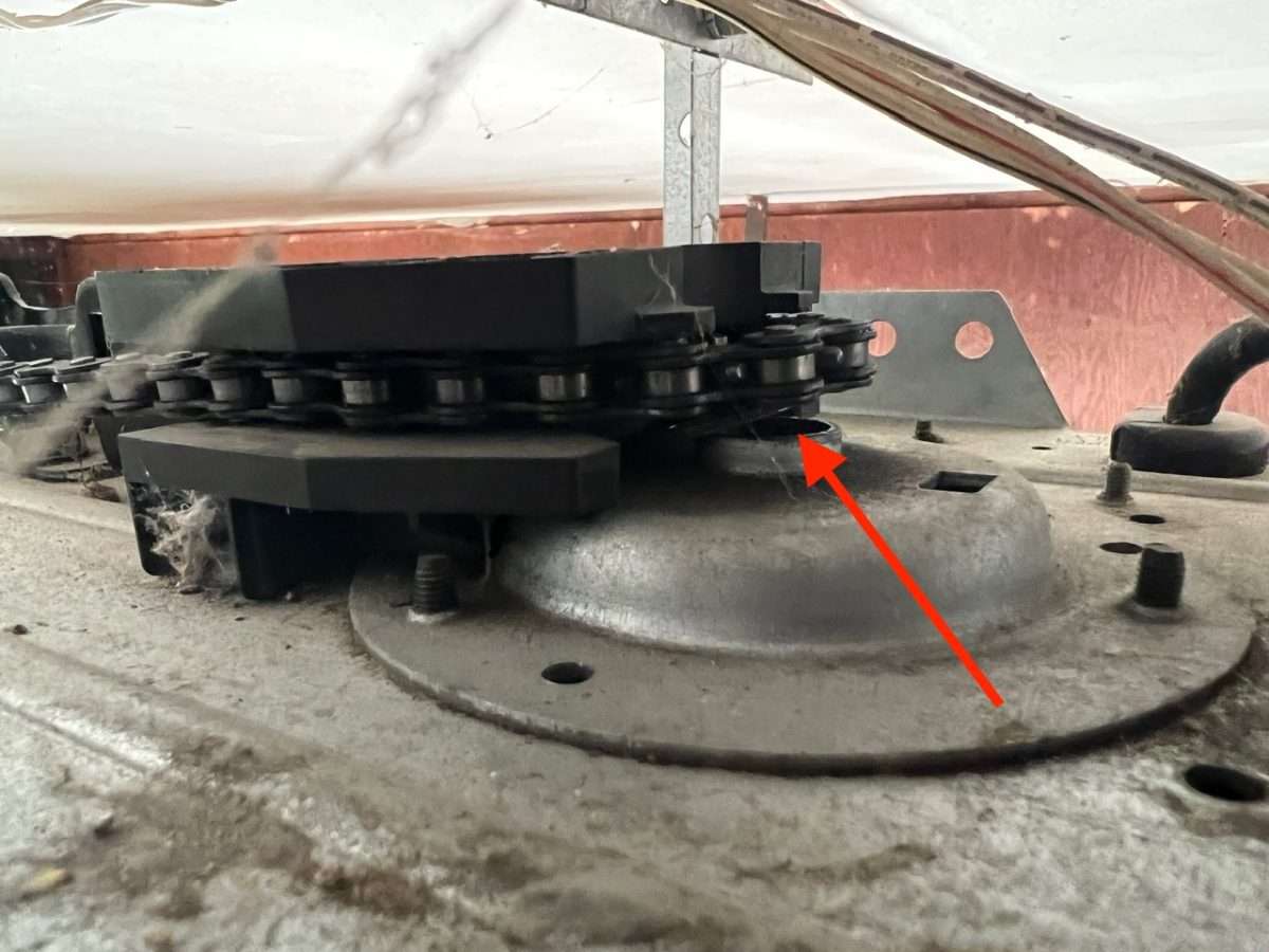 Sprocket sheared off on garage door opener causing the chain to sag.