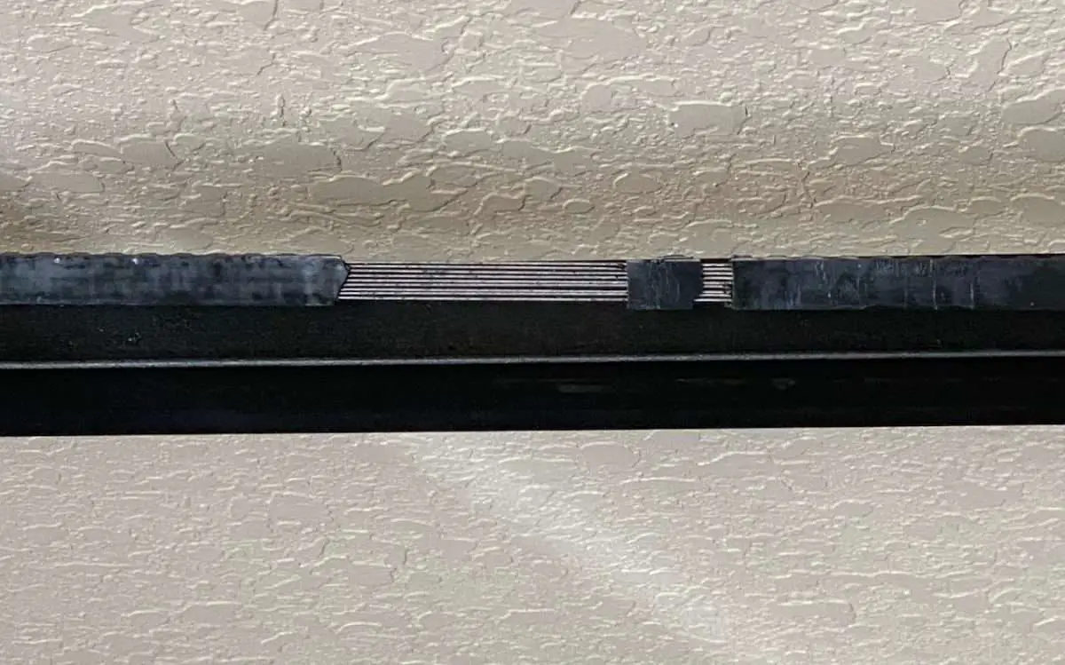 Stripped rubber drive belt on garage door opener.