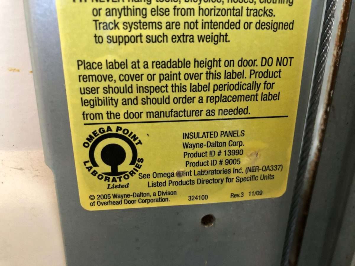 Yellow sticker on Wayne Dalton garage door showing the product ID#.
