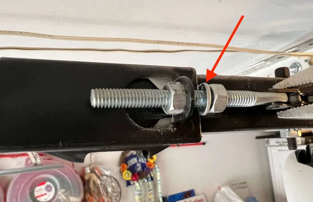 Lock washer on garage door opener chain tensioner.