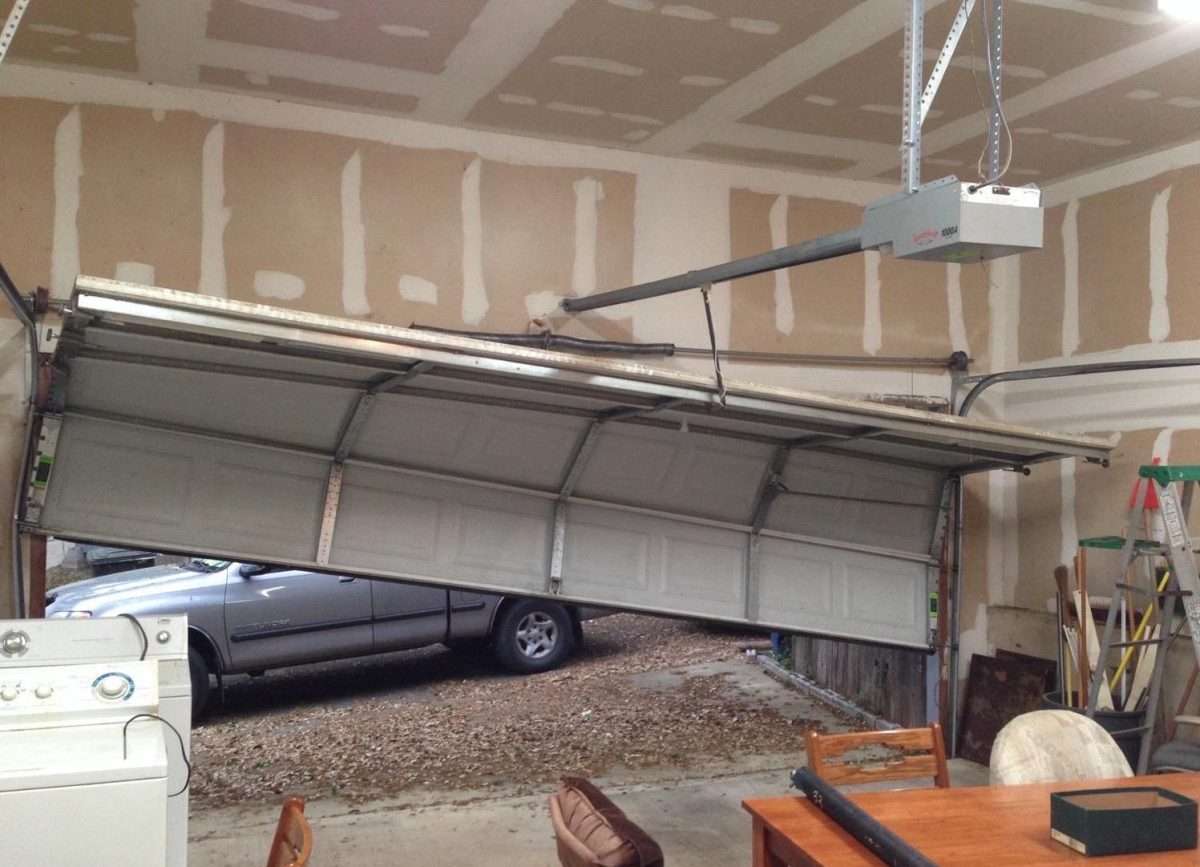 A more severe off track garage door that will most likely take a garage door technician to fix.