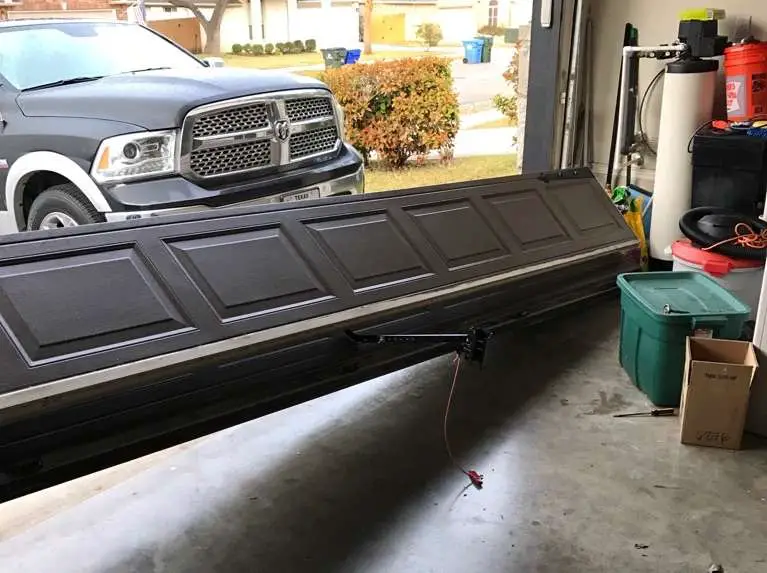 Garage door was completely off track and laying on the ground.