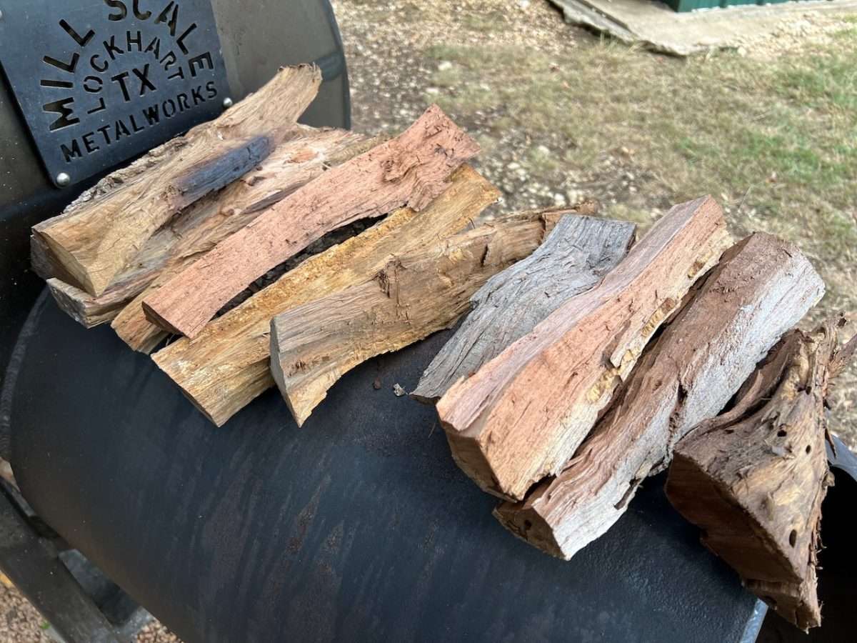 Small splits of wood for smoking jerky on offset smoker.
